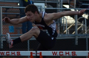 Dylan Campbell flies over a hurdle for Warsaw Friday night (Photo by Jim Harris)