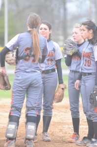 Kaleigh Speicher talks with catcher Kayla Snider (No. 31) as Kara Dishman and Sid Hernandez look on.