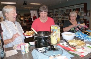 Mary Erb, Cindy Keirn, and Becky Pressler enjoy a hearty helping of friendship while sampling dishes during last week’s Revolving Recipe Round-Up. This group meets at the Library at 6 p.m. the fourth Tuesday each month to share and swap recipes. (photo provided)