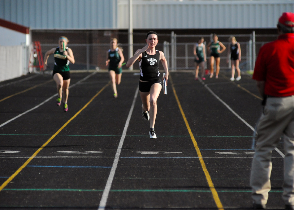 Warsaw's Ann Harvout pulls away during the final leg of the 4x100 relay Tuesday night. Warsaw easily beat Northridge and Wawasee in the NLC triangular. (Photos by Mike Deak)