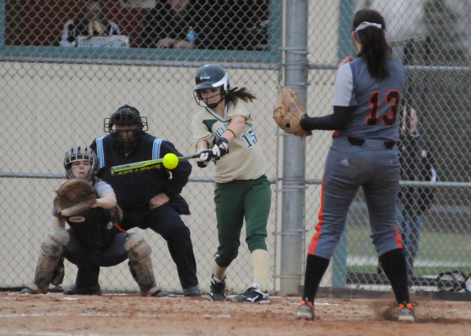 Wawasee's Paige Hlutke rips an RBI single during a five-run fourth inning of Wawasee's 10-7 win at Warsaw Monday night. (Photo by Mike Deak)