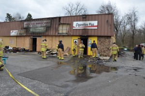 Members of the Warsaw Fire Department investigate the cause of a fire that destroyed one local business and damaged two others. (Photo by Alyssa Richardson)