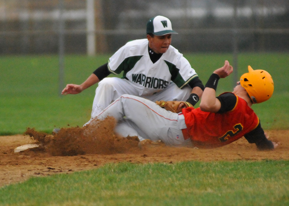 Wawasee second baseman Isaac Rigdon tags out Daniel Asbury trying to steal during Wawasee's 6-2 win. (Photos by Mike Deak)