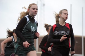 Catherine Yankosky of Wawasee zips past NorthWood's Jessica Borkholder for a win in the 100-meter dash.
