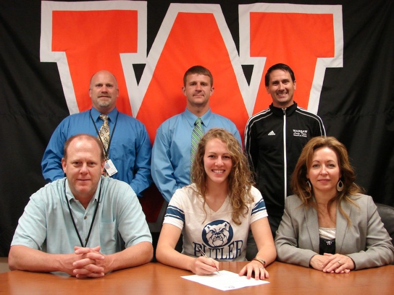 Warsaw senior Samantha Jensen will continue her track career at Butler University. The standout discus thrower is shown above in the front row flanked by her parents Phil and Debbie. In back are Warsaw Athletic Director Dave Anson, Warsaw throws coach David Bailey and Warsaw girls track coach Scott Erba (Photo provided)