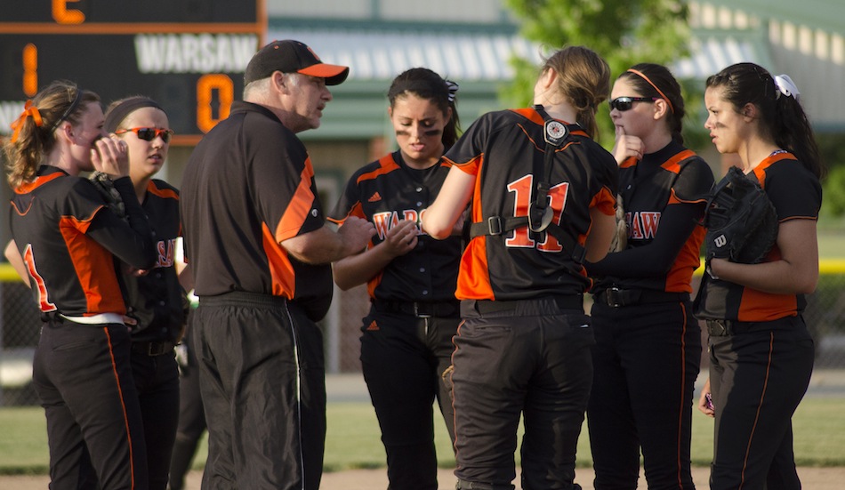 Warsaw softball coach Jim Speicher talks to his team during its sectional semifinal game versus Concord Wednesday night (Photos by Jim Harris)