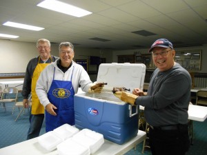 Despite the lack of a parade, Milford Kiwanians still held the annual Nelson's Chicken barbecue at Milford Community Center. From left are Milford Kiwanis members Clark Jones, Dick Roose and Chuck Bird. 