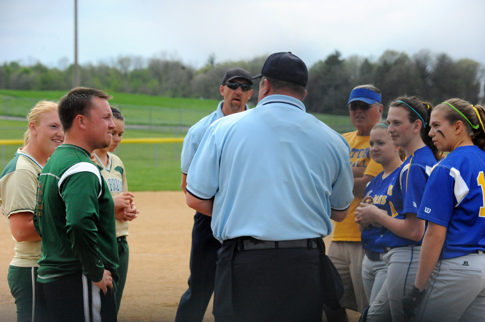 The captains and coaches from Wawasee and Triton meet with home plate umpire Brian Barger and field umpire Gene Teel before Tuesday's matchup. (Photos by Mike Deak)