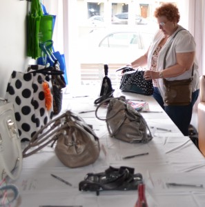 Joni Truex of Warsaw looks over a purse during a Saturday evening to raise money for Combined Community Services. Truex was the winner of a freshwater pearl necklace that was donated for the event.