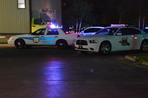 Indiana State Police surround a body shop in Milford Monday night. (Photo by Deb Patterson)