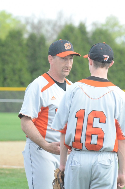 Warsaw baseball coach Mike Hepler shares a few words of wisdom with pitcher Kevin Hawley Friday night at Goshen. The Tigers routed the Redskins 11-0 in NLC play (Photos by Scott Davidson)