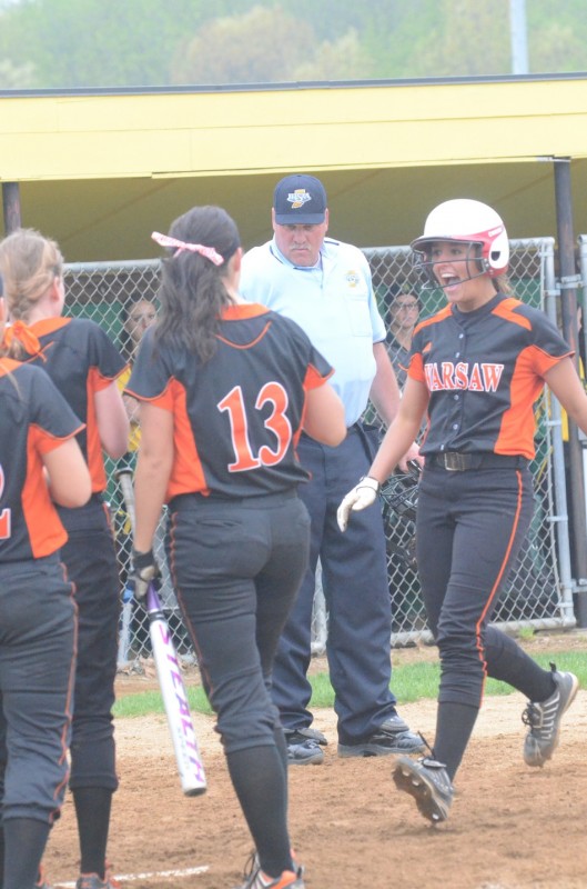 Ashley Ousley of Warsaw reacts as she reaches home plate after slugging a solo home run Friday night (Photos by Scott Davidson)