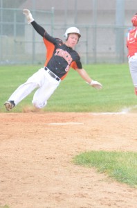 Tanner Balazs slides safely into home for Warsaw's first run in sectional action Saturday in Elkhart (Photos by Scott Davidson)