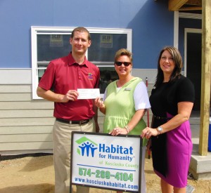 From left are Habitat for Humanity of Kosciusko County Executive Director Christon Clark, who receives a donation check from Stephanie Salyer and Lori Richcreek of MutualBank. (Photo provided)