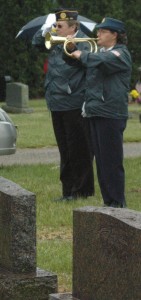 Lorree Corbat of American Legion Post 223 plays “Taps” at the Syracuse Cemetery. Memorial Day activities were shortened due to the inclement weather. (Photo by Lauren Zeugner)