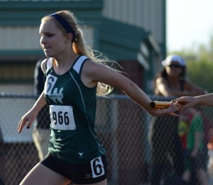 Sophomore Catherine Yankosky of Wawasee takes a handoff during the 4 X 100 relay Tuesday night.