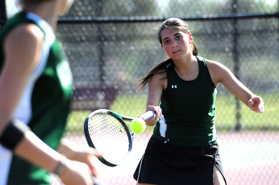 Wawasee's Jada Antonides returns a volley while one doubles teammate Sam Prins positions herself during their match at Whitko. (Photos by Mike Deak)