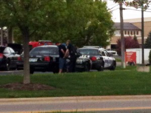 A Warsaw Police officer takes a man into custody for allegedly attempting to cash fraudulent checks at 1st Source Bank, Warsaw. (Photo provided)