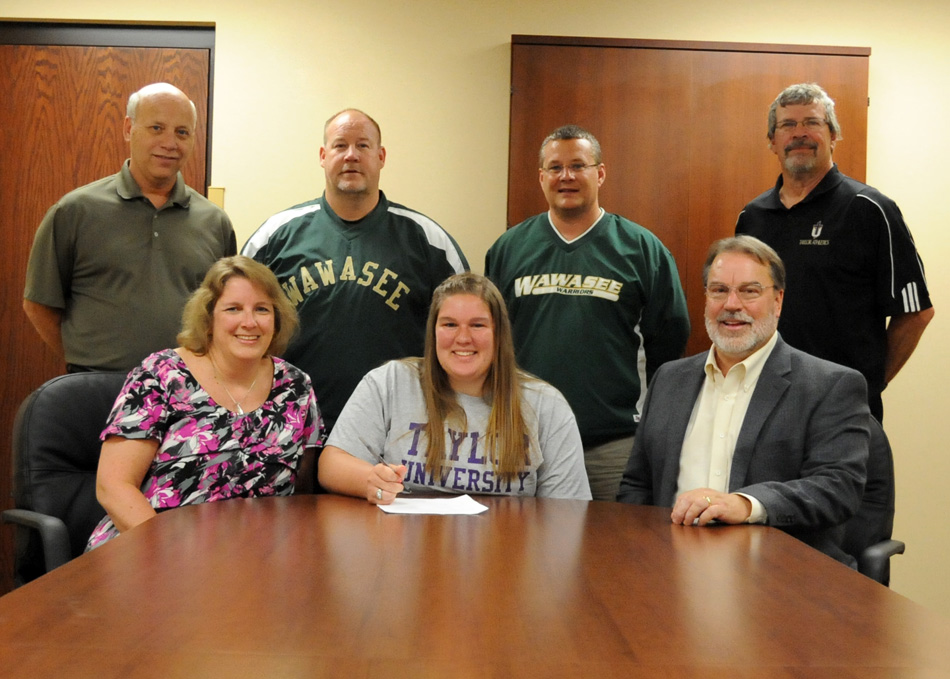 Wawasee High School senior Jordan Edington has chosen to continue her track and field career at Taylor University. Edington has starred in shot put. Pictured with Jordan in the front row are parents Michelle and Dr. Thomas Edington. In the back row are Wawasee athletic director Steve Wiktorowski, Wawasee throwing coach Scot McDowell, Wawasee track head coach Scott Lancaster and Taylor University women's track head coach Ted Bowers. (Photo by Mike Deak)