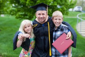 Master of Business Administration graduate Matthew R. Metzger with children Megan Metzger (left) and Hunter Metzger (right).  (photo provided)