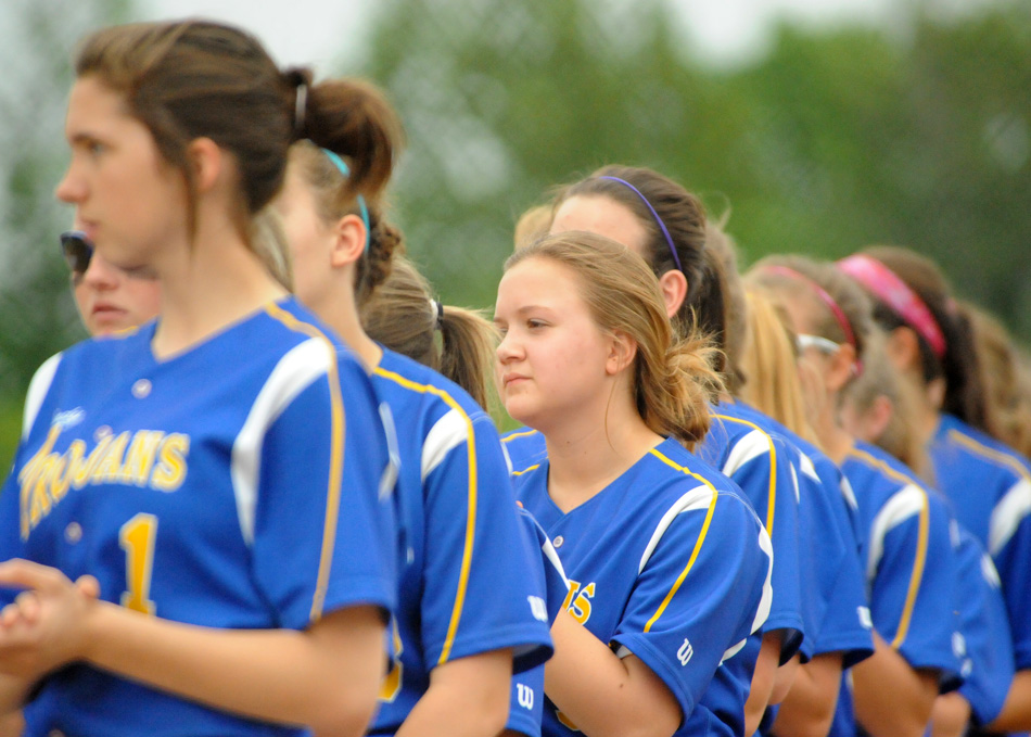 Jenae Kreft, center, and Triton stand at attention during pregame ceremonies at the Lakewood Park Christian Softball Regional.