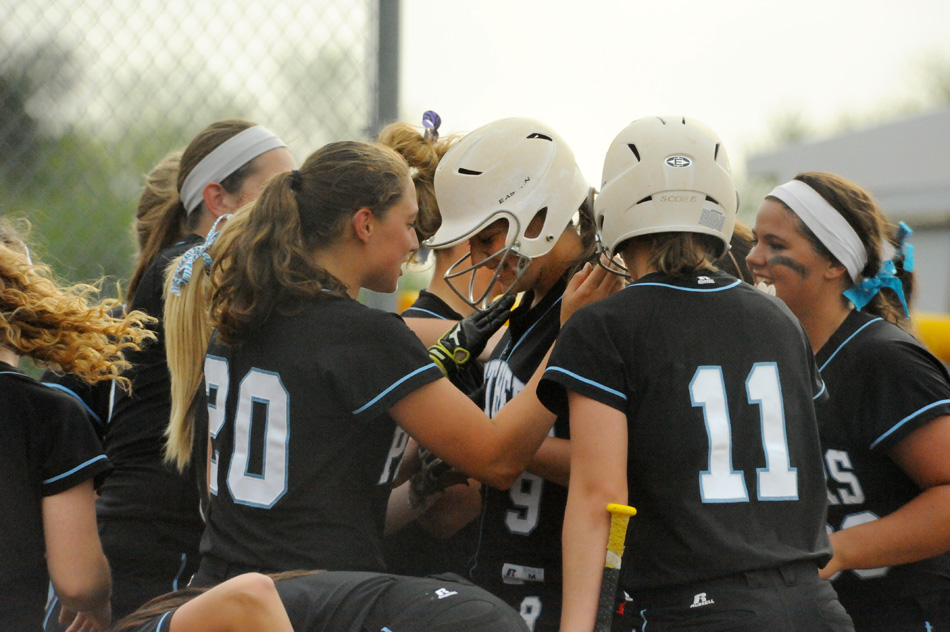 Lakewood Park Christian's Suzanne Grimm, center, is mobbed by her teammates after belting a two-run homer during the Panther's 9-0 win over Triton in the regional Tuesday night. (Photos by Mike Deak)