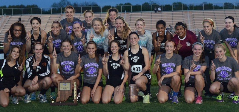 The Warsaw girls track team strikes a championship pose after claiming the program's seventh straight sectional title Tuesday night.