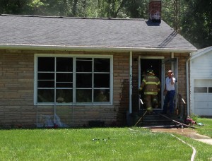 Firefighters quickly contained a fire at a rural Atwood home Tuesday afternoon that was set by the homeowner's son. (Photo by Stacey Page)