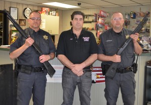 Fleck was in Warsaw just last month to accept a donation of guns for the Akron Police Department from Eagle Creek Firearms.  From left are Fleck, Eagle Creek Firearms owner Jay Jacobs, and Akron Police Officer Justin Gearhart. (Photo by Stacey Page)