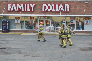 Turkey Creek Fire Territory Firefighters prepared to check the roof for a gas leak at Family Dollar, Syracuse