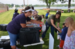 Parents line up with their children at Bixler Park on Center Lake in Warsaw to receive a free, nutritional packed lunch provided by Warsaw Community Schools.  (photo by Alyssa Richardson)