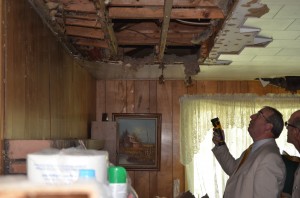 Warsaw Code Enforcement Officer Larry Clifford, left, and Warsaw Building Commissioner Todd Slabaugh inspect the interior of a house at 1405 Ranch Rd., Warsaw, that will be demolished unless the owners come up with funding for repairs in the next 30 days. (Photo by Stacey Page) 