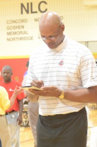 Former Ohio State and Pacers star Clark Kellogg signs an autograph for a fan Friday.