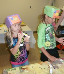 Hannah Likens and Olivia Ousley enjoy bone-shaped cookies during Friday Family Food and Fun where they explored digging underground with crafts and treats. (Photo provided)
