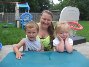 Assistant caregiver Kourtney Flannery, center, supervises Enzo Piersall, left, and Zoey Reed during outdoor play at Teen Parents Succeeding in Syracuse. (Photo provided)