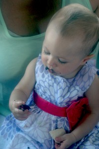 Nilah Jo Moreno Elst, 9 months, enjoys her first bite of chocolate as she shares a birthday cupcake with her mom, Kaytea Moreno Elst, on the Dixie Cruise. (Photo by Lauren Zeugner)