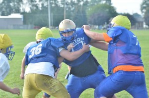 Junior Justin Heffner (middle) will help to anchor the line on both sides of the ball for the Trojans.