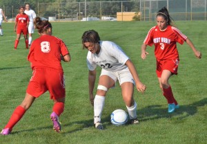 Wawasee's Caitlin Clevenger keeps control between West Noble's Olga Landeros (8) and Selene Murillo (3). 