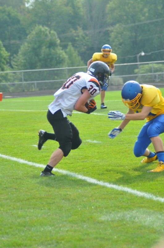 Justin Arscott gains some yardage for the undefeated Warsaw JV team Saturday.