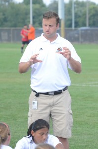 Warsaw girls soccer coach Peter Lucht makes a point with his team at halftime Monday night at WCHS.