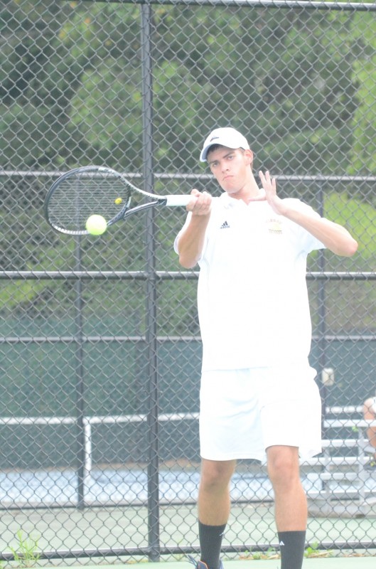 Warsaw senior standout Kyle Wettschurack smashes a forehand at Mishawaka Marian Monday. The Tigers won 4-1 to improve to 3-0 (Photos by Scott Davidson)