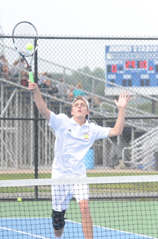 Senior Evan Miller reaches for an overhead Monday at Marian. Miller paired with Nic Jansen to win at No. 1 doubles for the undefeated Tigers. 