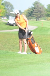 Elizabeth Meadows chips on to the green for Warsaw Tuesday.
