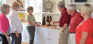 A small group of area residents, mostly Indiana University alum and patrons/collectors of art, attended a special event at the home of Steve and Sally Springer, Northshore Drive, Syracuse. The event was a presentation by the Indiana University Art Museum on identifying fakes and forgeries in the visual arts. Shown looking at a few pieces of African art, from the left, are Sally Springer, Heidi Gealt, director of the IU Art Museum; Diane Pelrine, IU Art Museum’s Raymond and Laura Wielgus Curator of the Arts of Africa, Oceania and the Americas who led the interactive presentation; Curt Simick, president emeritus of IU Foundation, Steve Springer and Judy Simic. (Photo by Deb Patterson)