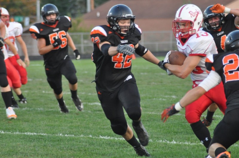 Warsaw linebacker Kyle Heckaman pursues Plymouth's Dakota Brooke Friday night. The Tigers rallied to win 20-19 in their NLC opener (Photo by Amanda Farrell)