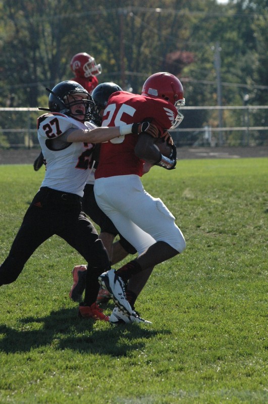 Michael Anderson of Warsaw wraps up a Redskin during JV football action Saturday at WCHS.