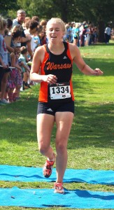 Brooke Rhodes hits the finish line for Warsaw Saturday.