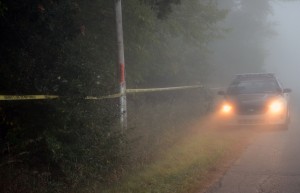 A Kosciusko County Sheriff’s Department deputy guarded a wooded area near Suburban Acres Mobile Home Park Sunday evening and all night where it is believed human remains were found. (Photo by Stacey Page)