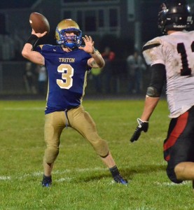 Cole Creighbaum looks to toss a pass over a Falcon defended in the third quarter.