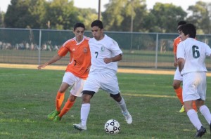 Julio Solano of Concord is pressured by Zach Tucker during NLC action at Concord Wednesday night.